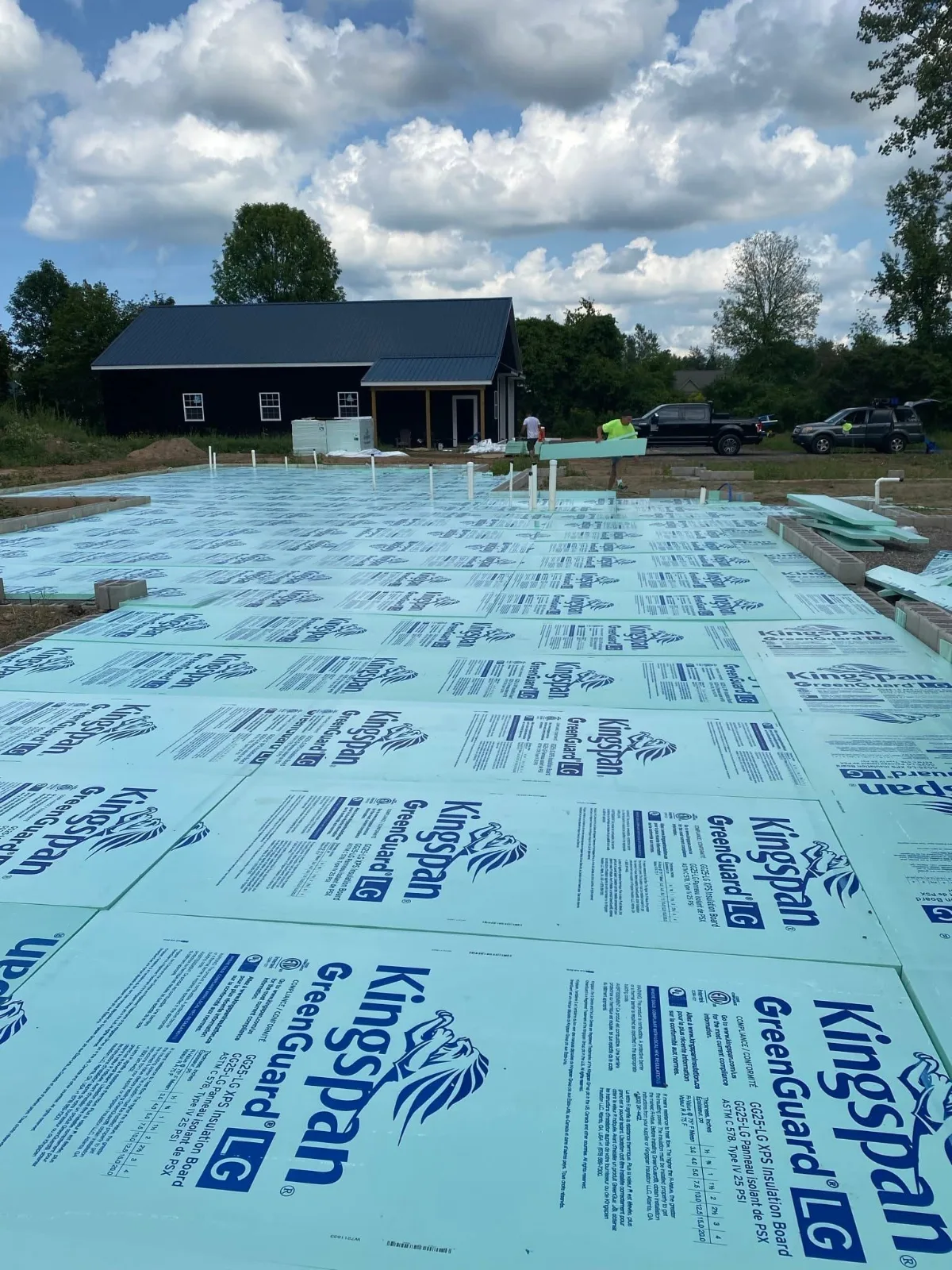 Drain stub-ups rising through insulation board on a new house’s slab, before the concrete pour