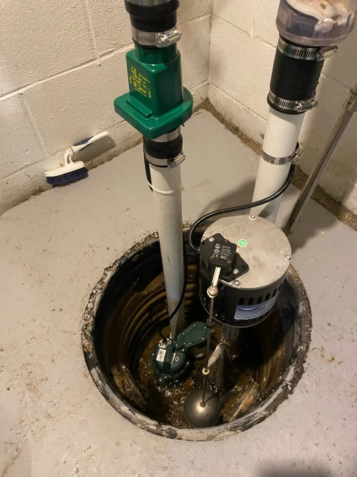 A new sump pump and check valve in a basement sump pit